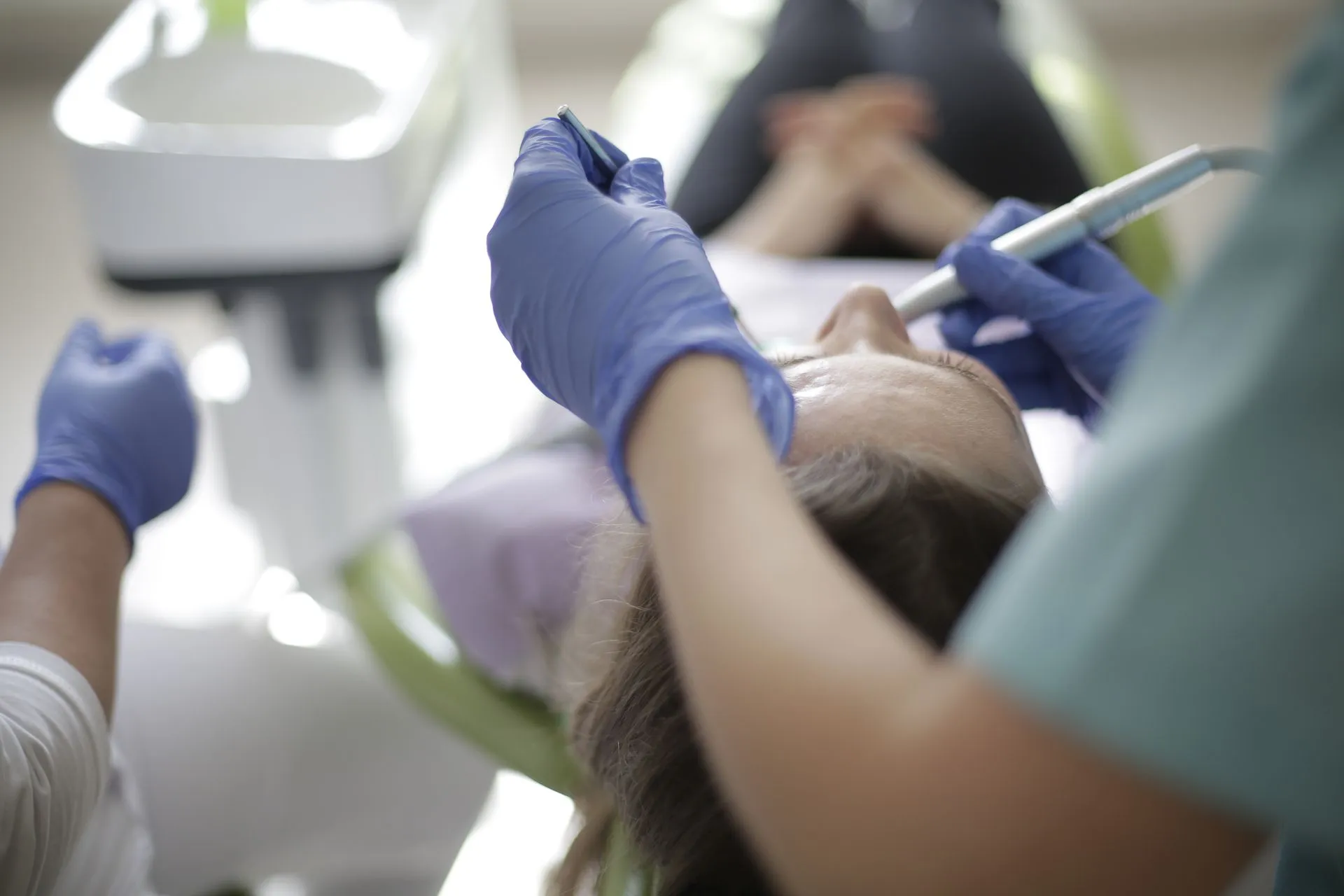 Dentista realizando una obturación dental a un paciente